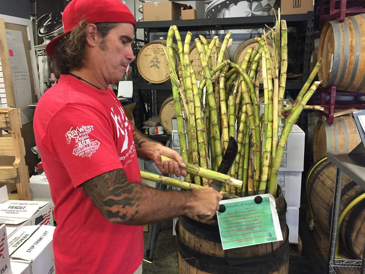 Paul Menta prepares to squeeze the juice out of fresh Florida sugar cane at Key West First Legal Rum Distillery.