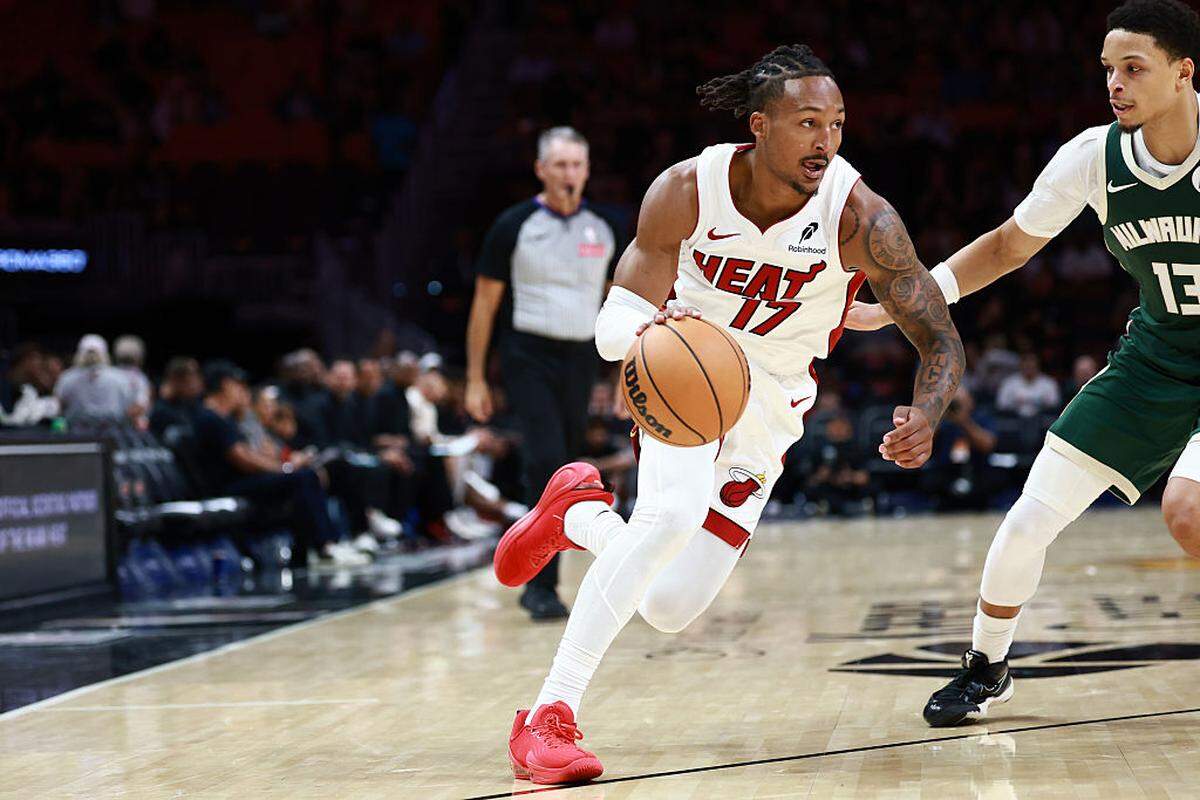 Jahmir Young of the Miami Heat drives to the net against Ryan Rollins #13 of the Milwaukee Bucks during the second half at Kaseya Center on October 6, 2025 in Miami.