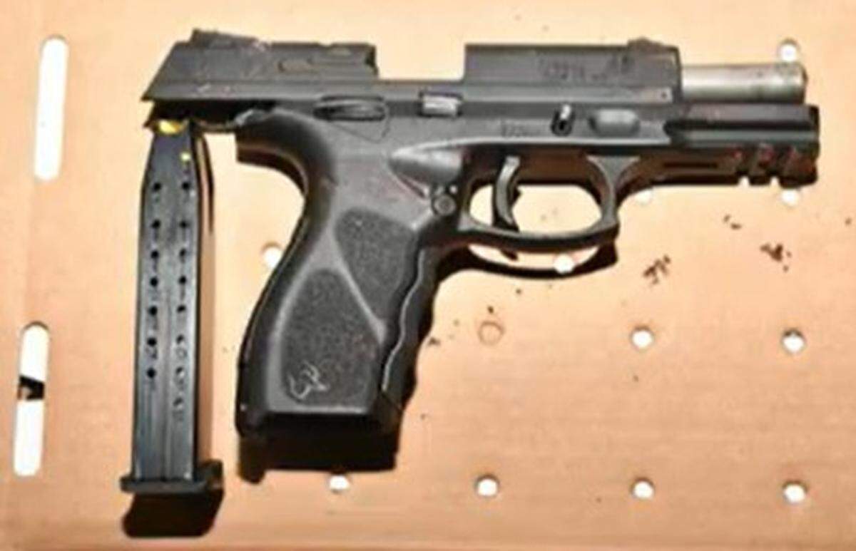 A semiautomatic handgun and its magazine are displayed on a table. The Miami-Dade Sheriff’s Office said the weapon was used in a shootout with a deputy in Goulds on Sept. 16, 2025.