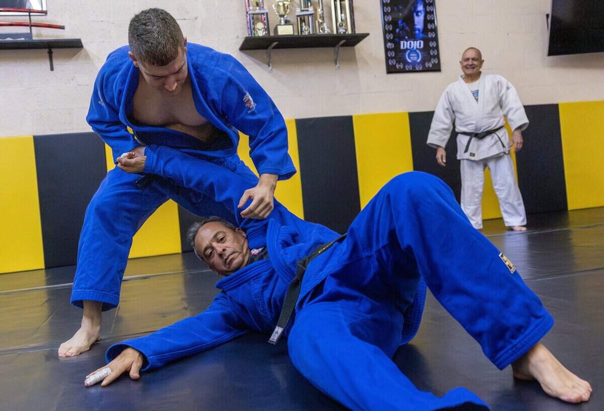 Jon Paul, a fourth-degree judo black belt, demonstrates a throw on Pedro Lopez while Alberto Fernandez, president of Baragua Judo Kai and Jon Paul's father, watches at Baragua Judo Kai in Miami, Fla., on Wednesday, June 3, 2026.