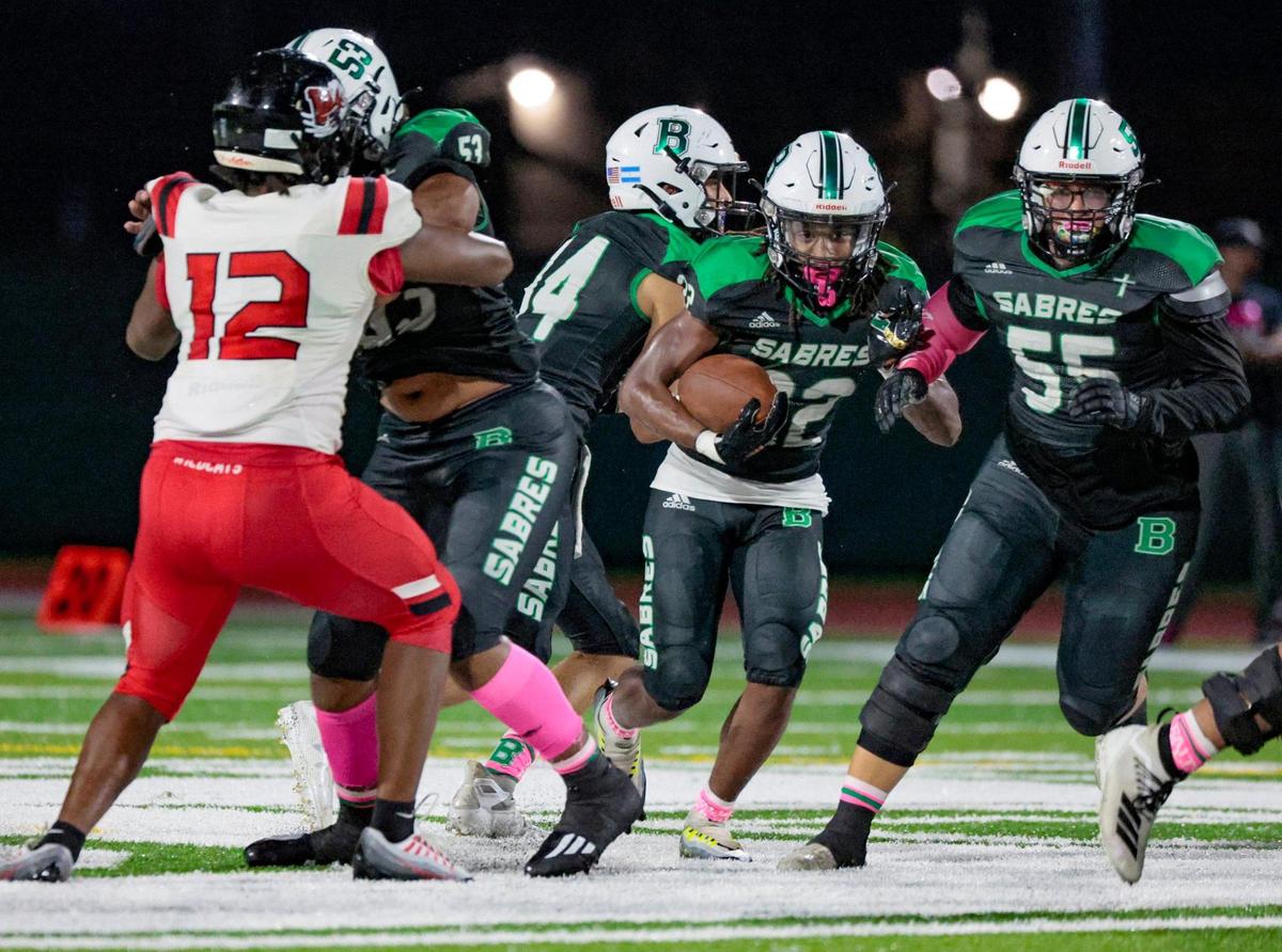 St. Brendan’s Luis Lugo (22) carries for yardage against Westland Hialeah in the second quarter at St. Brendan High School on Friday, October 14, 2022.
