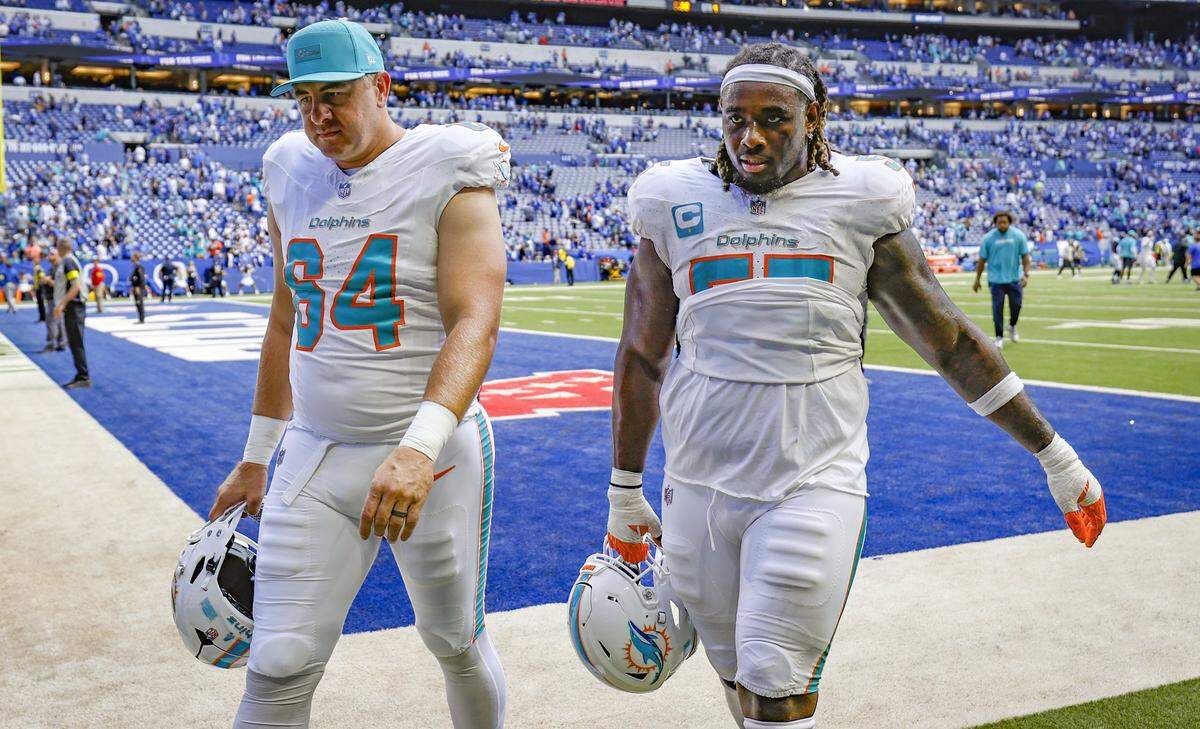 Miami Dolphins offensive tackle Daniel Brunskill (64) and Miami Dolphins guard Aaron Brewer (55) walk off the field after the Indianapolis Colts defeat the Dolphins 33-8 in an NFL game at Lucas Oil Stadium in Indianapolis on Sunday, September 7, 2025, in Indianapolis.