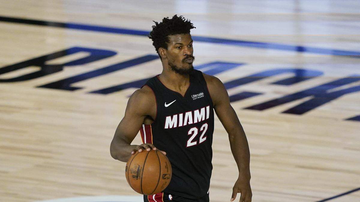 Miami Heat’s Jimmy Butler (22) dribbles down the court during an NBA basketball game against the Toronto Raptors. Foot injuries can be common in basketball and take time to heal.