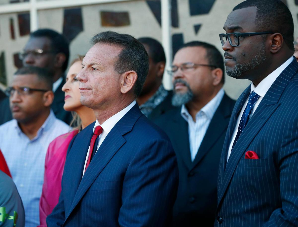 Suspended Broward County Sheriff Scott Israel, center, listens to comments by his attorney at a news conference after new Florida Gov. Ron DeSantis suspended Israel, Friday, Jan. 11, 2019, in Fort Lauderdale, Fla., over his handling of February’s massacre at Marjory Stoneman Douglas High School in Parkland.