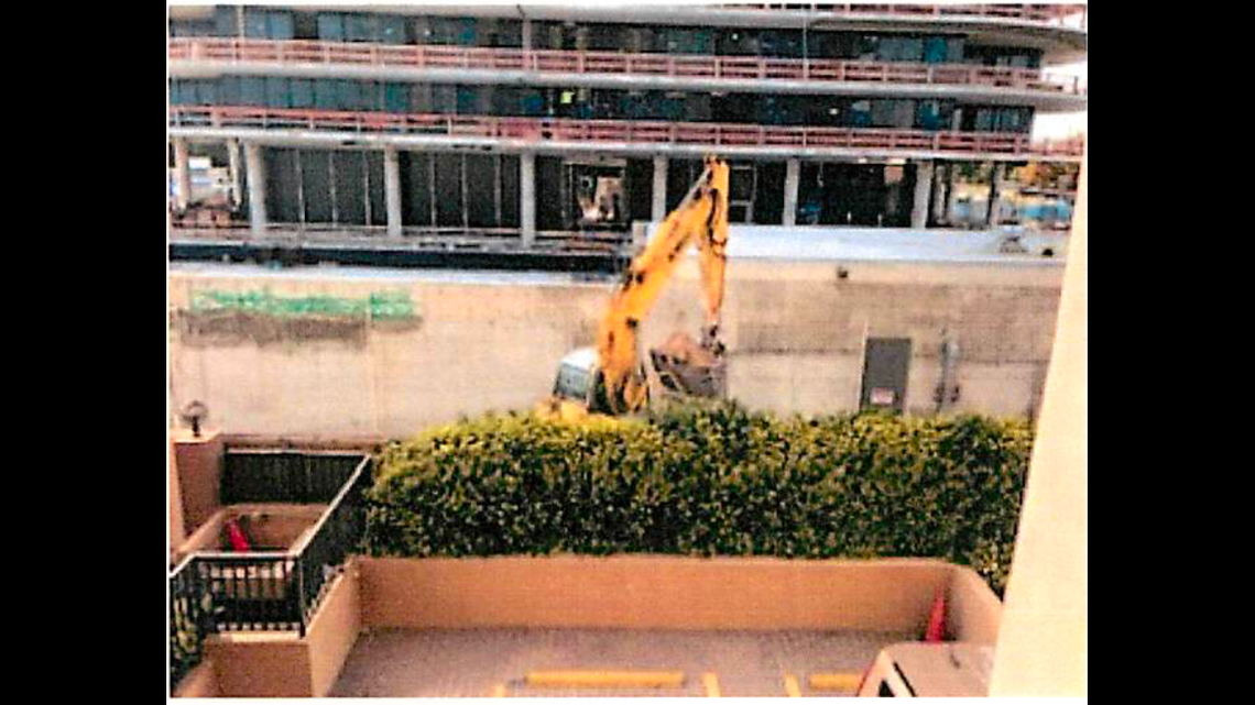 Heavy machinery works along the outer wall of Champlain Towers South.