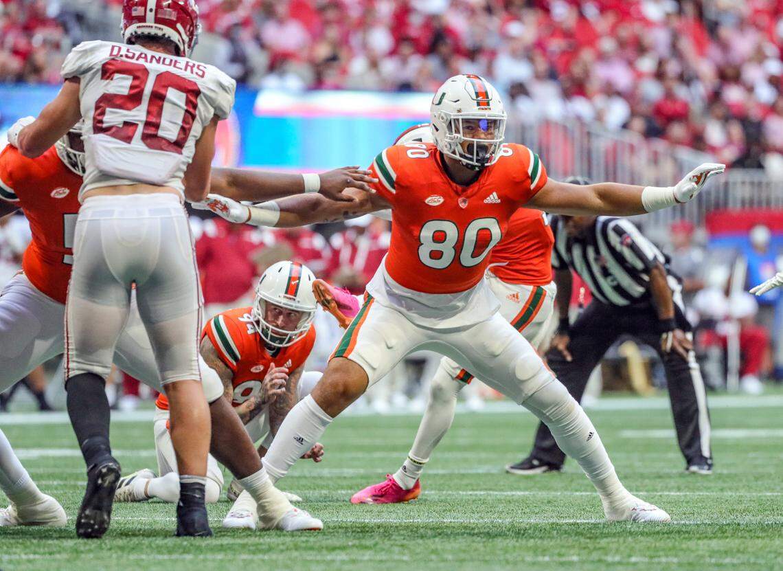 Miami Hurricanes freshman tight end Elijah Arroyo (80) blocks for place kicker Andres Borregales (30) as Borregales kicks a field goal in the third quarter against the Alabama Crimson Tide at Mercedes-Benz Stadium in Atlanta on Saturday, September 4, 2021.