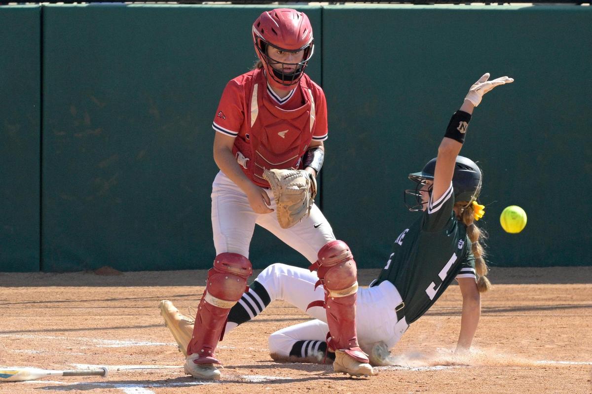 Doral Academy catcher Gianna Juan waits for the throw at home plate as Melbourne’s Hailey Turner (5) scores the winning run during the sixth inning of an FHSAA State Championship Softball Game, Saturday, May 28, 2022, in Clermont, Fla. (Phelan M. Ebenhack for the Miami Herald)