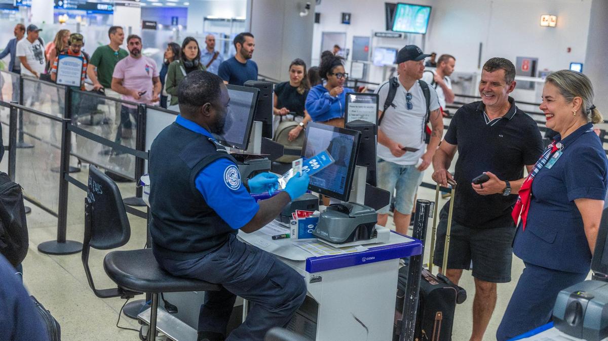 In this file photo, TSA agents verify identities at Miami International Airport on Wednesday, May 7, 2025.