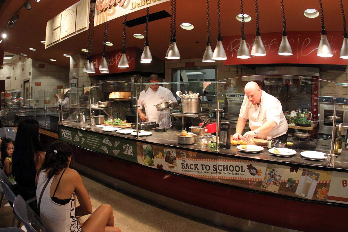From left, Chefs Timon Balloo and Michael Jacobs cook seafood dishes at the Whole Foods Market in Coral Gables in 2011.