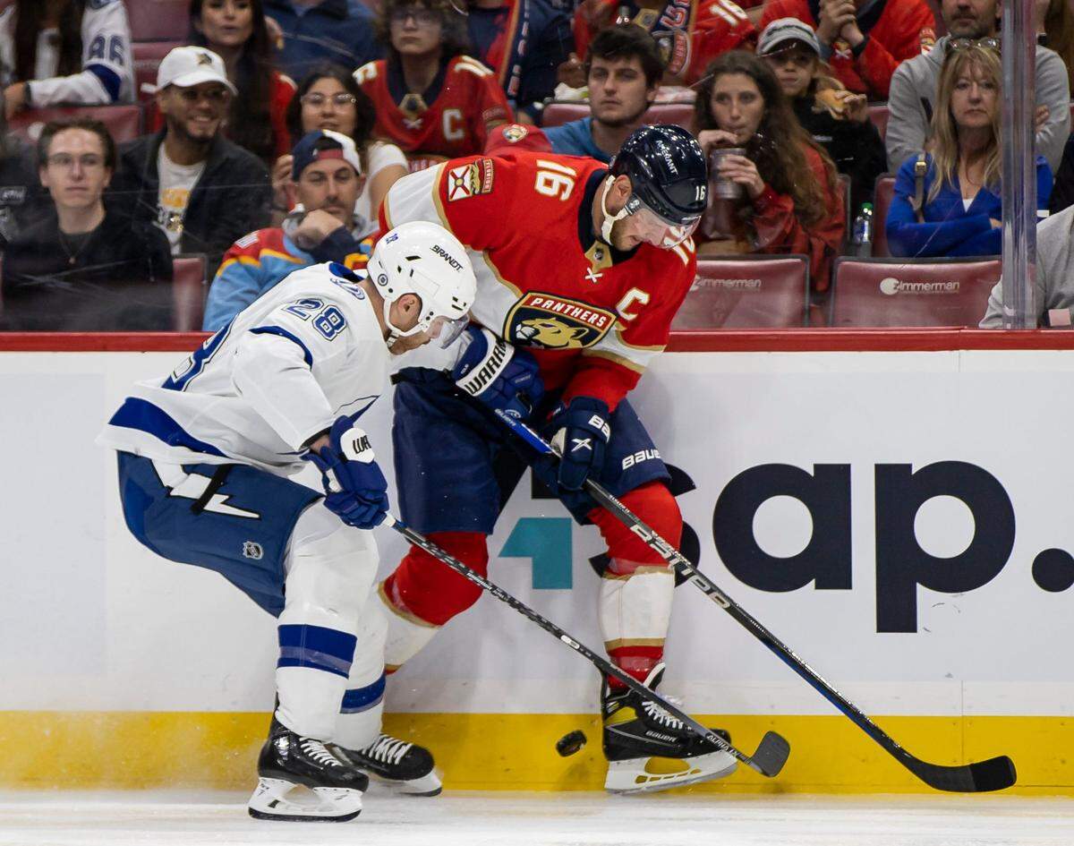 Florida Panthers center Aleksander Barkov (16) and Tampa Bay Lightning defenseman Ian Cole (28) fight for possession of the puck during the first period of an NHL hockey game at the FLA Live Arena on Monday, Feb. 6, 2023, in Sunrise, Fla.
