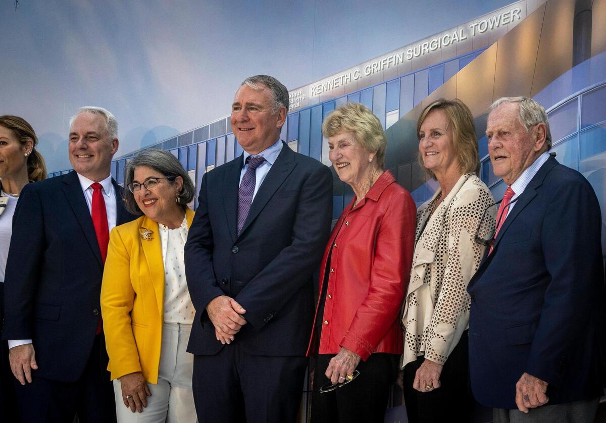 Posing for photos in front of a rendering of the new Kenneth C. Griffin Surgical Tower are, from left, Matthew A. Love, president & CEO of Nicklaus Children’s Health System; Daniella Levine Cava, mayor, Miami-Dade County; Citadel founder and CEO Ken Griffin; Barbara Nicklaus; Nan O’Leary, daughter of Jack and Barbara Nicklaus and member of the Nicklaus Children’s Health System board; and Jack Nicklaus, on January 31, 2023.