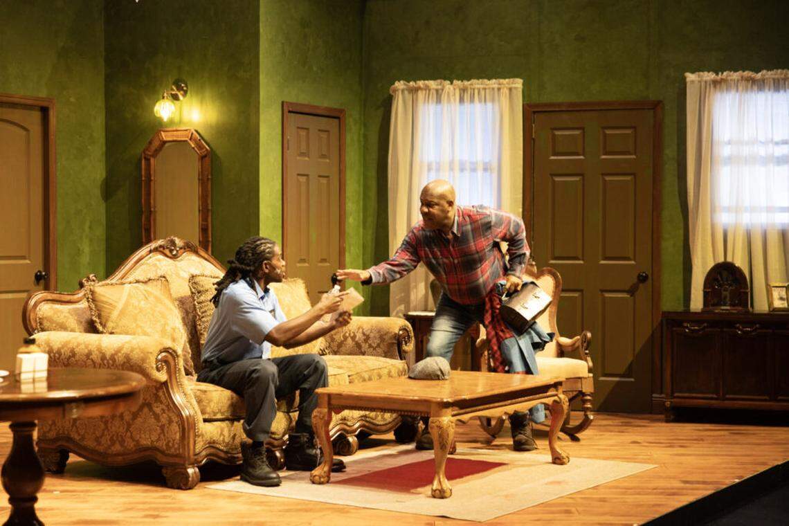 Thaddeus Daniels, right, talks to Jarryd Joseph as Peanut in M Ensemble’s production of “Searching for Willie Lynch” now at the Sandrell Rivers Theatre.