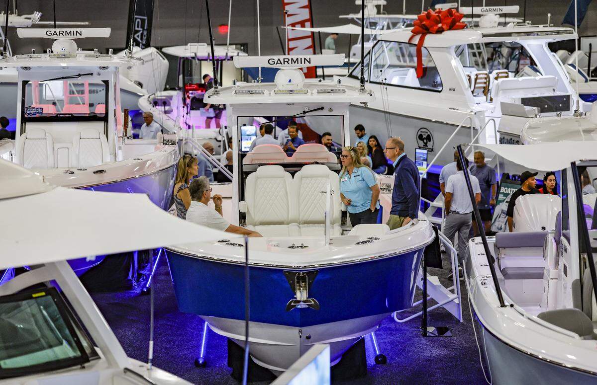 Attendees tour a boat on display at the Miami Beach International Boat Show in the Miami Beach Convention Center on Miami Beach, Florida on Thursday, February 12, 2026.