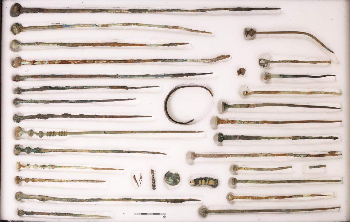 Bronze needles or robe pins found at the bottom of the well.