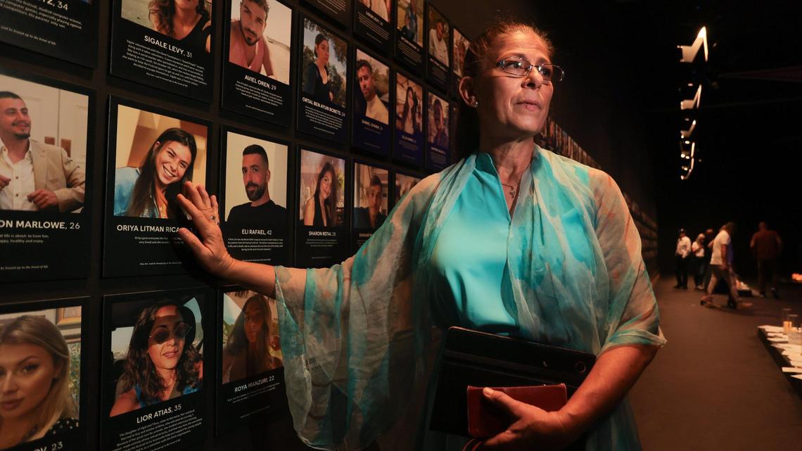 Hannie Ricardo, 59, touches the picture of her late daughter, Oriya Litman Ricardo, at Nova Exhibition Miami at Greenwich Studios in North Miami. The Nova Exhibition is a walk-through experience honoring the victims and survivors of the Hamas attacks on October 7, 2023