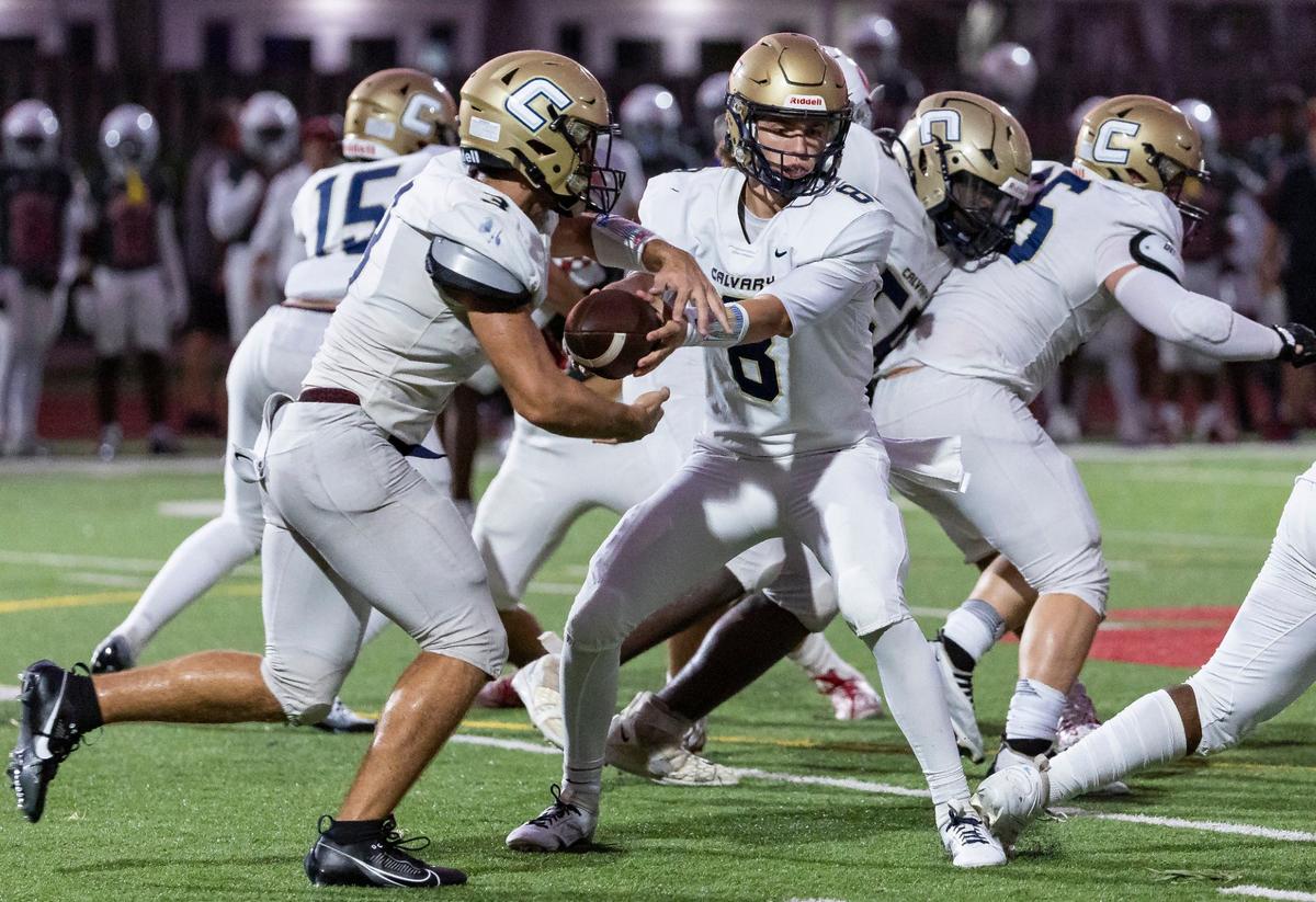 Calvary Christian Academy Eagles quarterback Camden Hartzell (8) passes the ball to running back Lucas Yalale (3) in the first half of their high school football game against the Cardinal Gibbons Chiefs at Cardinal Gibbons High School on Friday, Sept. 27, 2024, in Fort Lauderdale, Fla.