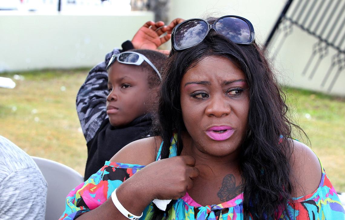 Joyce Tate, with her son Gabriel, tells the story of how her family, of Sweetings Cay, survived Hurricane Dorian. They were among a group of Freeport residents from all ages attending the Bahamas Thanksgiving Relief Lunch, organized by the Third Wave Volunteers Organization, at the Christ the King Church in Freeport on Nov. 23, 2019.