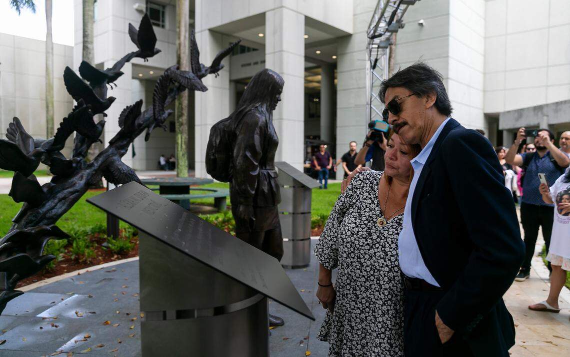 Gina and Orlando Duran, the parents of Alexa Duran, the FIU student killed when the FIU pedestrian bridge under construction collapsed on March 15, 2018, embrace during the unveiling of a sculpture at FIU’s main campus on Tuesday, the four-year anniversary of the crash. Six people were killed in the accident; the sculpture honors Alexa and the five others who died.