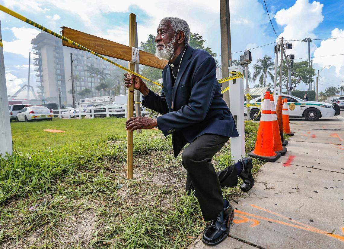 Clayton Harrell stops to pray one block west of the 12-story oceanfront condo, Champlain Towers South on Saturday, June 26, 2021. The condo tower partially collapsed early Thursday morning in the town of Surfside.