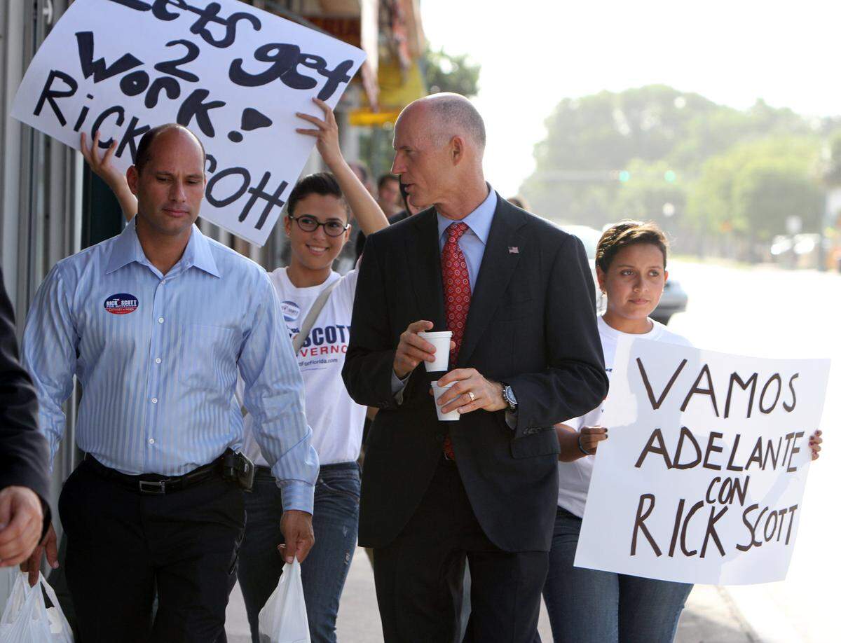 Florida Republican gubematorial candidate Rick Scott, center, kicks off a 6-day statewide bus tour with a stop at Versailles in Little Havana this Wednesday morning July 21, 2010. He is walking a few blocks to a radio station with Sweetwater Mayor Manny Marono for an interview.