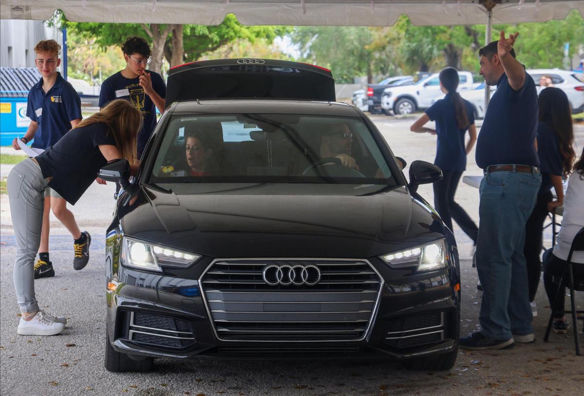 Several Broward volunteers deliver non-perishable food items to a driver to help deliver over 1000 Passover packages to feed Broward County’s most vulnerable. The event is organized by the Dorit & Ben J. Genet Cupboard in Davie.
