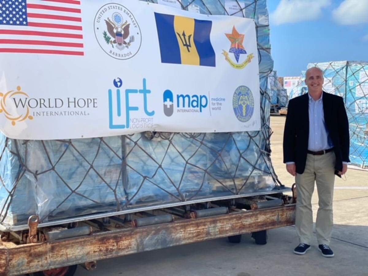 John Lyon of World Hope International, a relief and development nonprofit, stands next to a life-saving oxygen generator that was delivered to Bridgetown, Barbados to help in the fight against COVID-19. The systems arrived on Saturday, Nov. 13, 2021.