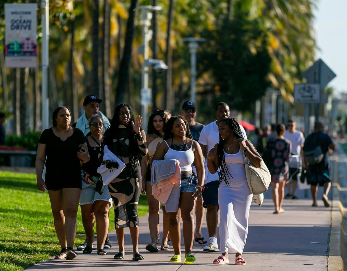 People walk down Ocean Drive in Miami Beach, Florida on Friday, Feb. 25, 2022.