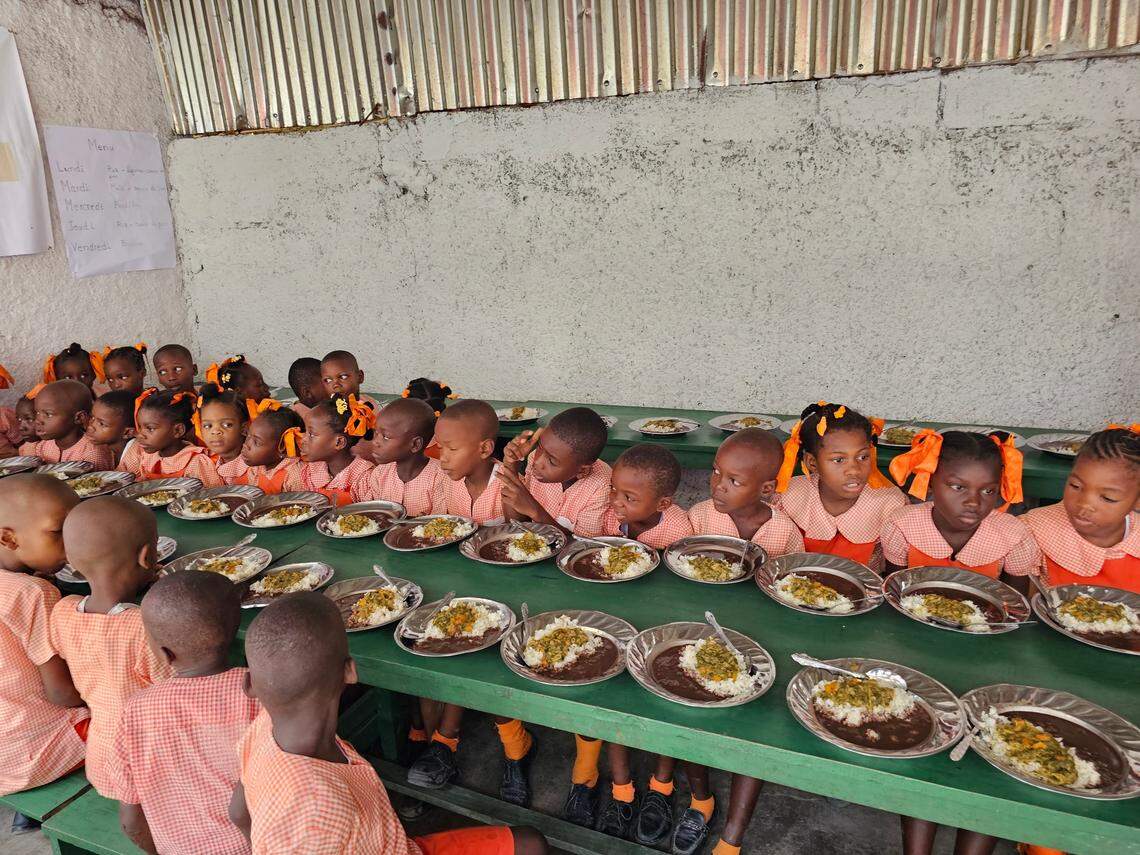 Students at the Elim School in Jérémie prepare to eat a free hot meal that was prepared with locally grown crops. The school feeding program is supported by the U.N. World Food Program, whose new executive director, Cindy McCain, visited the school on Monday, June 19, 2023.