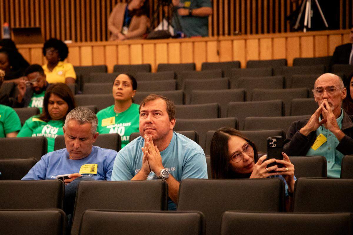 Residents of Miramar wearing green, Doral wearing blue and the Sierra Club members listen to a resident from Doral speak.