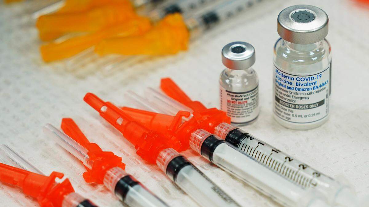 Pfizer, left, and Moderna bivalent COVID-19 vaccines are readied for use at a clinic Thursday Nov., 17, 2022, in Richmond. Va. (AP Photo/Steve Helber)