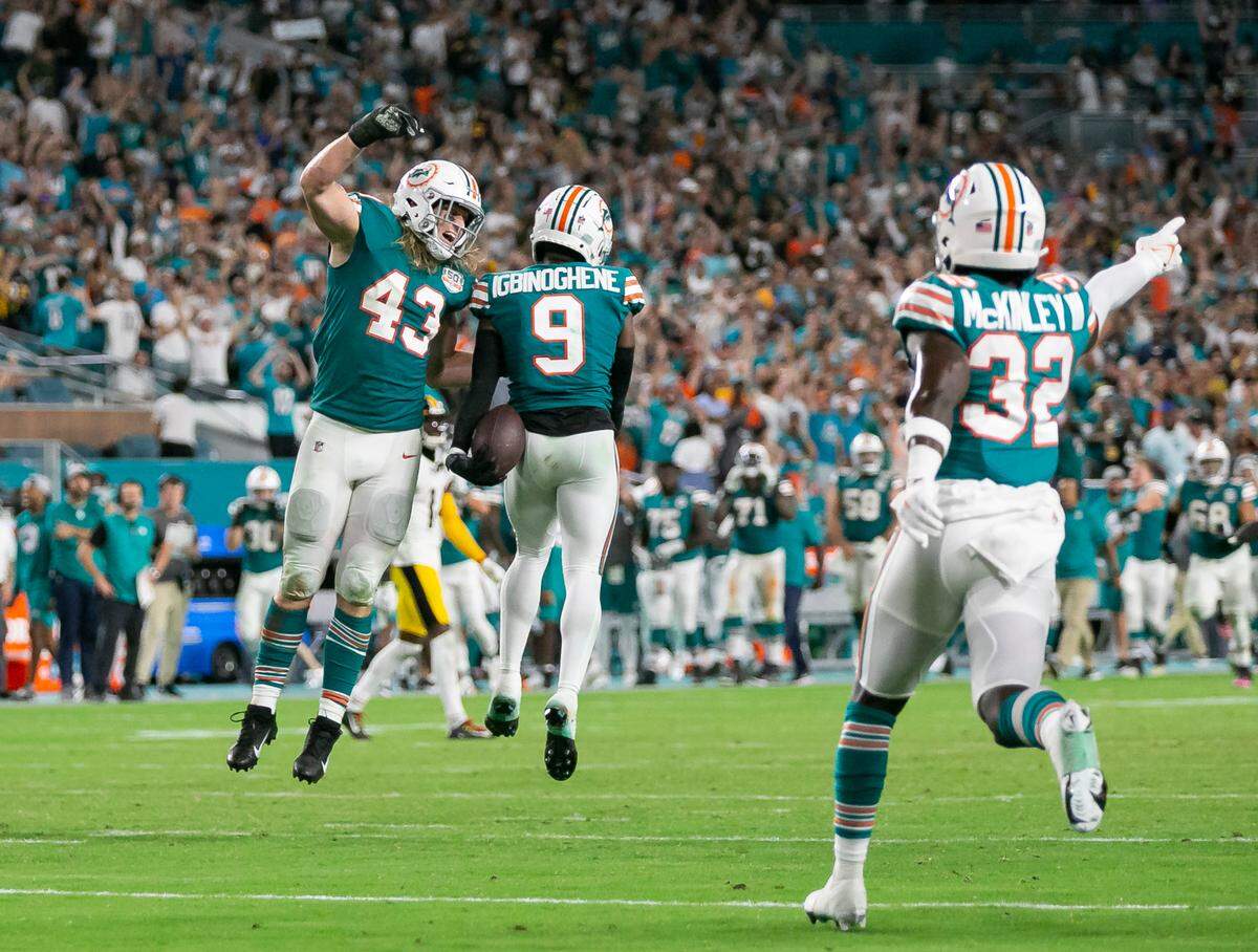 Miami Dolphins cornerback Noah Igbinoghene (9), linebacker Andrew Van Ginkel (43) and safety Verone McKinley III (32) celebrate after they defeated the Pittsburgh Steelers 16 to 10 during an NFL football game at Hard Rock Stadium on Sunday, Oct. 23, 2022, in Miami Gardens, Fla.