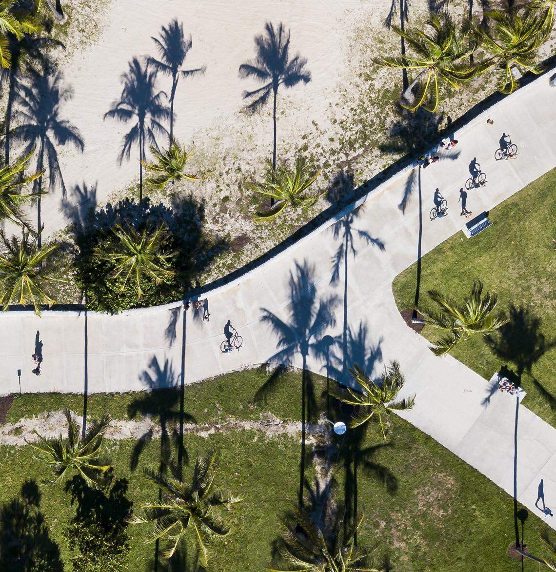 Visitors make their way through Lummus Park in Miami Beach, Florida on Saturday, May 16, 2020.