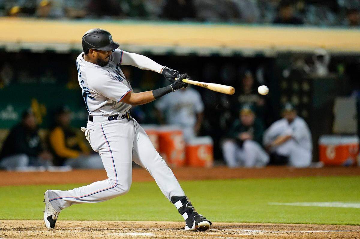 Miami Marlins’ Jerar Encarnacion hits a two-run double against the Oakland Athletics during the sixth inning of a baseball game in Oakland, Calif., Tuesday, Aug. 23, 2022.