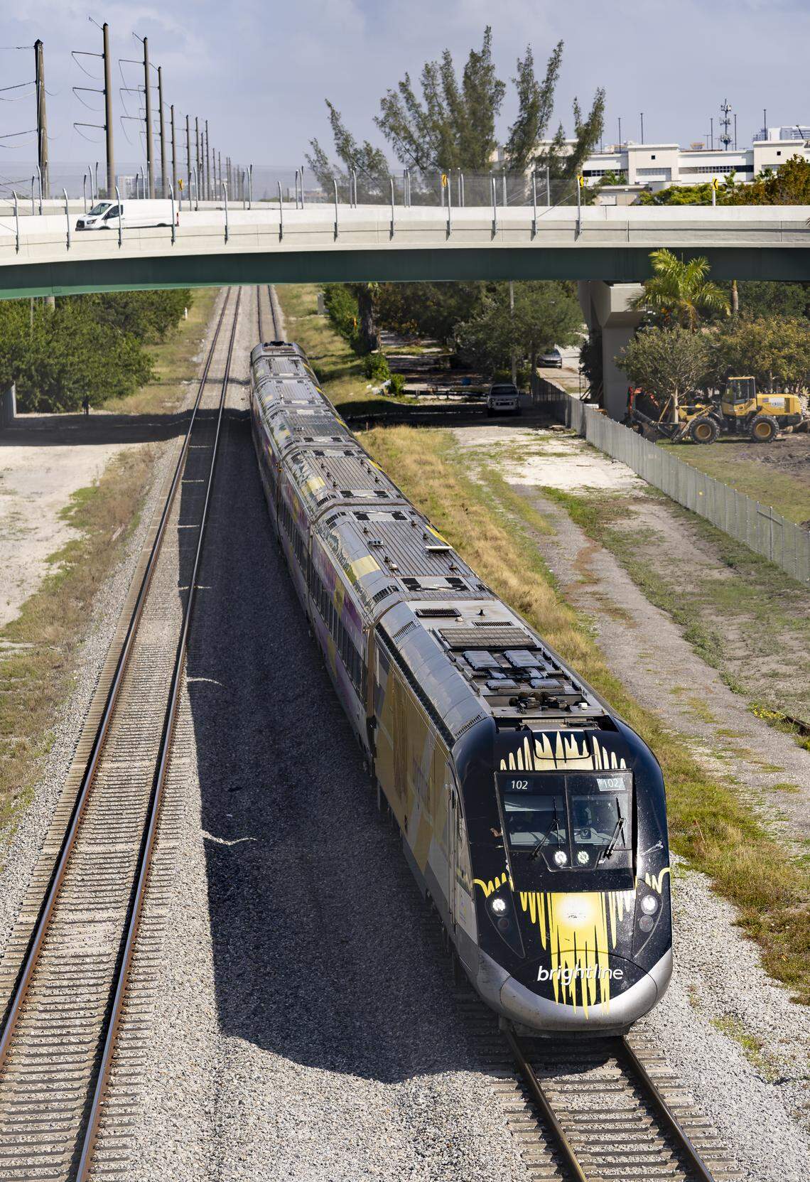 A train makes its way under a newly developed traffic ramp near Aventura Mall and a Brightline station on Wednesday, April 2, 2025, in Aventura, Fla. The horse-shoe shaped ramp takes drivers over the congested intersection of Ives Dairy Road and U.S. 1.