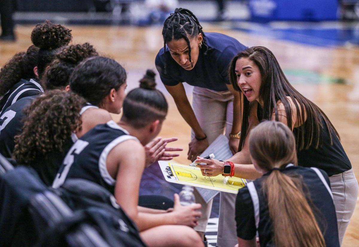 Miami Christian head coach Chanel Davila talks to the team during a timeout in the game against Faith Christian in the Class 2A girls basketball state championship game at the RP Funding Center in Lakeland on Saturday, February 26, 2022.
