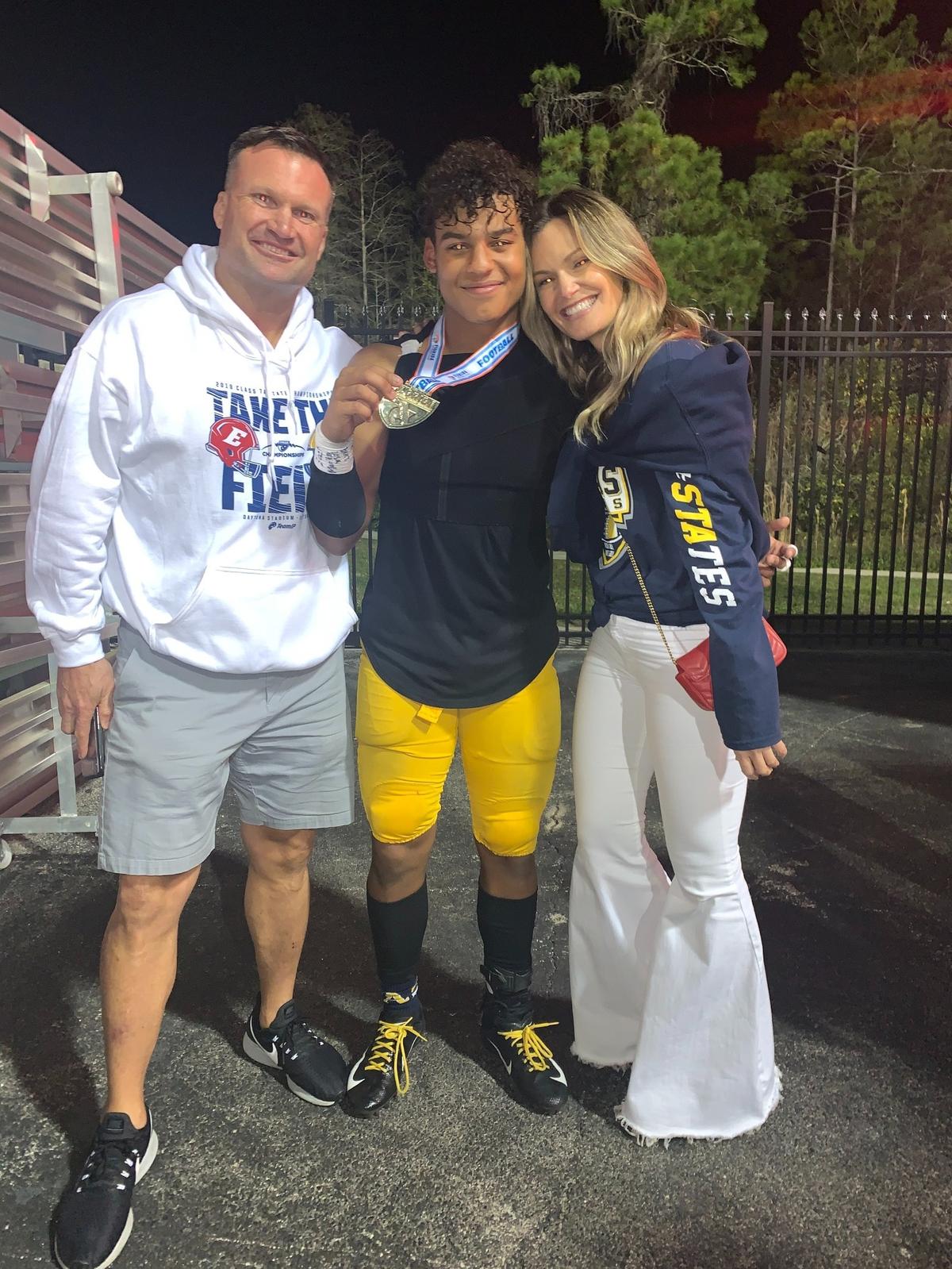 Miami Dolphins great Zach Thomas, Isaiah and Katina Taylor.