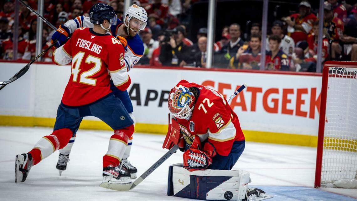 Florida Panthers goaltender Sergei Bobrovsky (72), right makes a save as Florida Panthers defenseman Gustav Forsling (42) holds back Edmonton Oilers center Connor McDavid (97) during the second period of Game 3 in the NHL Stanley Cup Final series at Amerant Bank Arena on Monday, June 9, 2025, in Sunrise, Fla.
