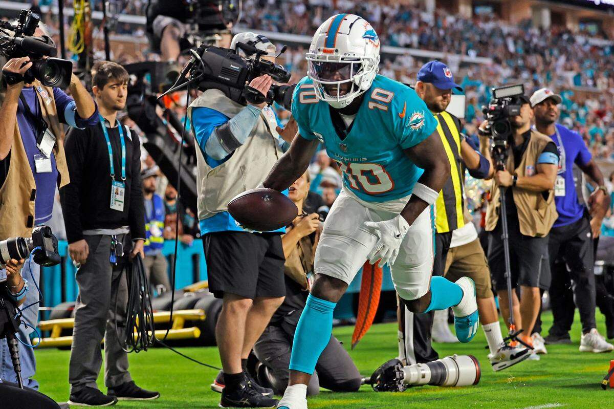 Miami Dolphins wide receiver Tyreek Hill (10) scores in the first half against the San Francisco 49ers during the first half of an NFL Football game at Hard Rock Stadium in Miami Gardens, Florida, on Sunday, December 22, 2024.