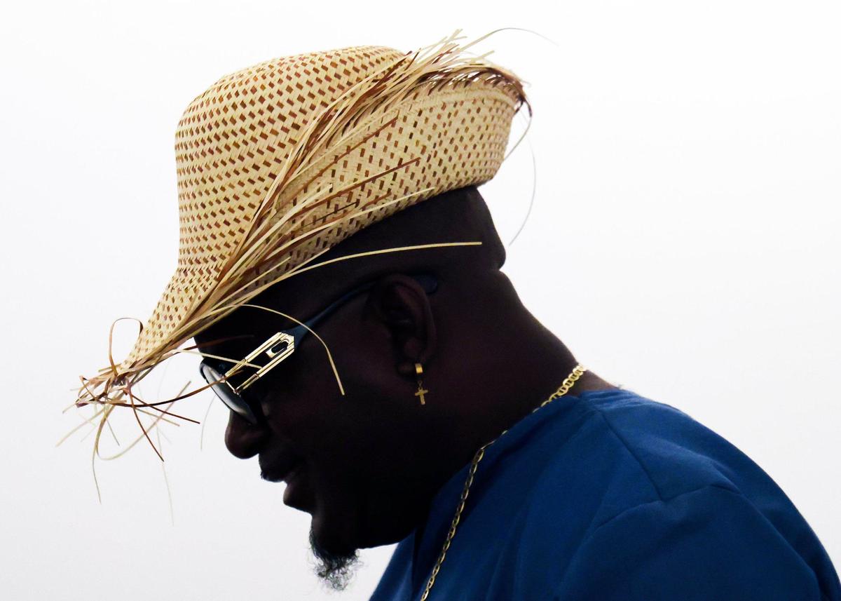 The maestro of the Haitian “Aroze Twoubadou” group, Jean Levelt Vital, wears a Haitian straw hat with designer sunglasses as he waits to perform during the Miami-Dade County Community Action and Human Services Department’s Office of New Americans’ Day of Welcome on Wednesday, September 18, 2024, at the Miami-Dade County Main Library in Miami, Florida.