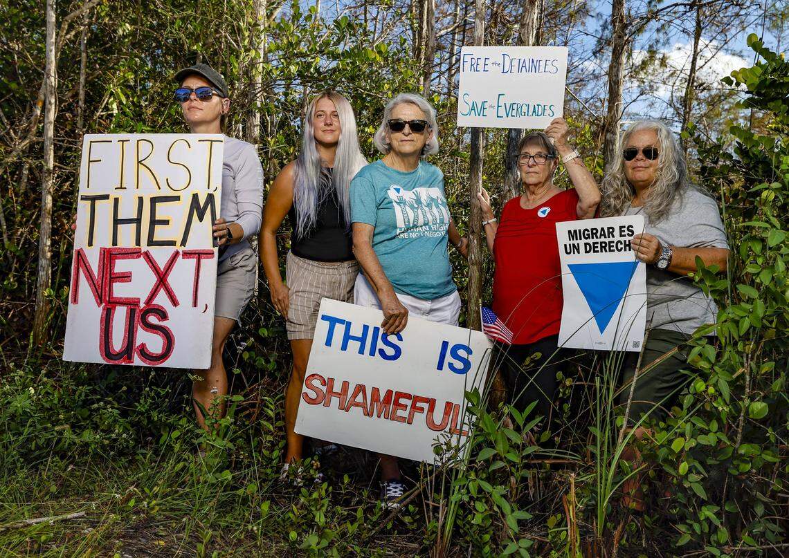 Amanda Lamb, Andrea Scherben, Christine Davies, Debbie Wehking, and Nora, standing from left to right, across the street from the front entrance of Alligator Alcatraz, on Wednesday, November 19, 2025. The group of protesters have been camping during the day outside of the immigration detention facility since it's opening. Alligator Alcatraz is located at Dade-Collier Training and Transition Airport inside Big Cypress National Preserve in Ochopee, Florida.