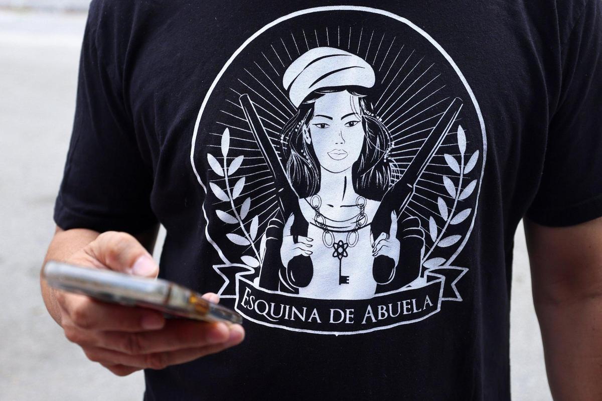 Fabian Martinez, founder of Esquina de Abuela, checks for messages as he visits the old Allapattah community space on Tuesday, April 29, 2025.