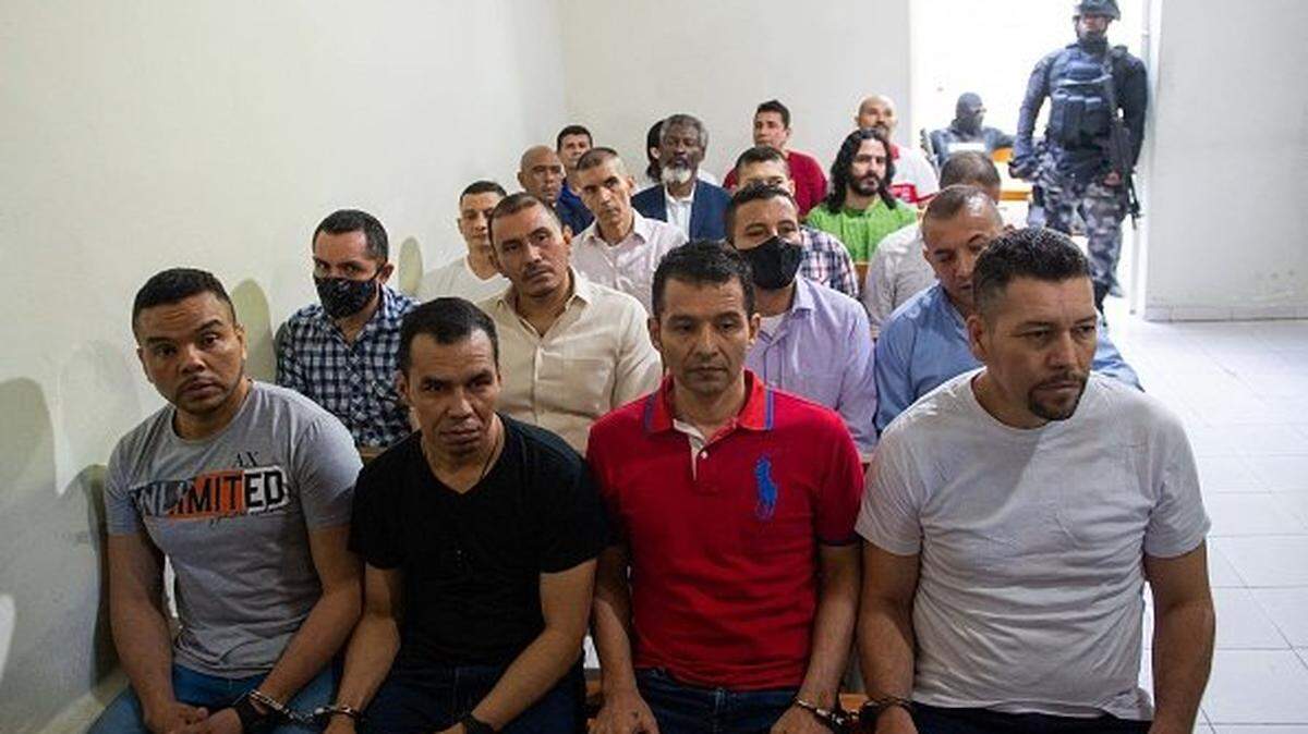 Colombian men, who are suspects and accused of involvement in the assassination of former Haitian President Jovenel Moise, sit in handcuffs during a hearing at the Court of Appeals in Port-au-Prince, Haiti, on January 27, 2025. Moise was murdered in July 2021. (Photo by Clarens SIFFROY / AFP) (Photo by CLARENS SIFFROY/AFP via Getty Images)
