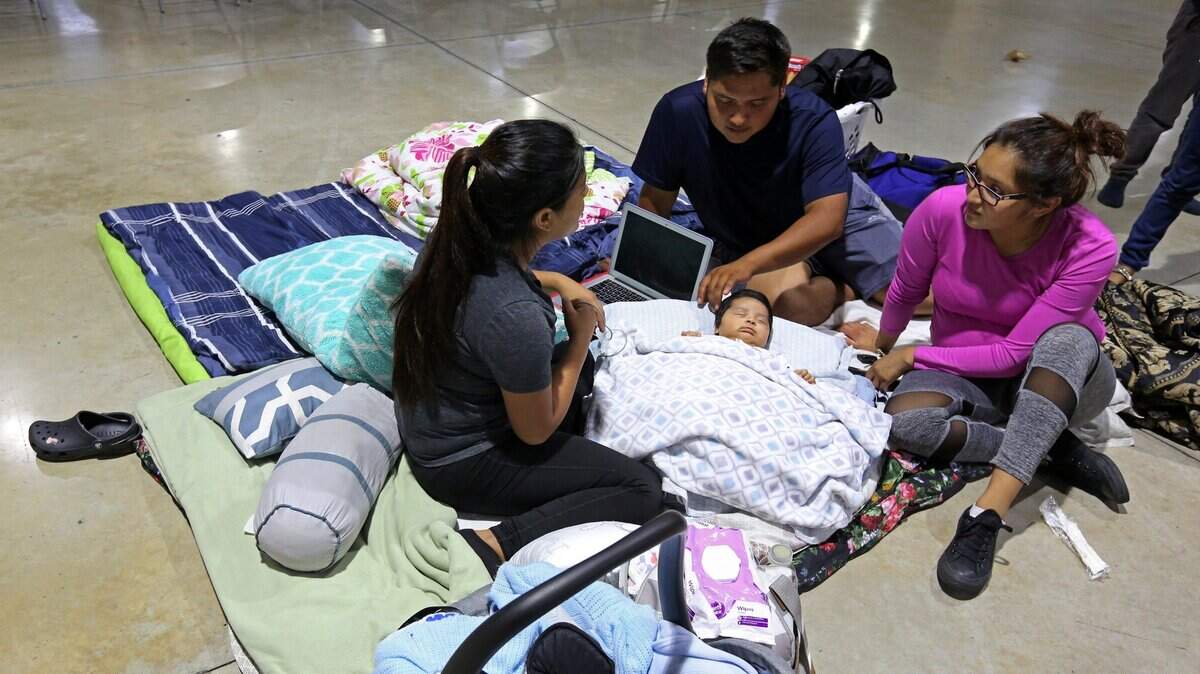 Nelly Diaz and Albino Perez watch over their 2-month-old son, Nicholas, along with his aunt, at the hurricane shelter at the Miami-Dade County Fair and Exhibition, at 10901 Coral Way, Miami during 2017's Hurricane Irma. The family and many of their relatives came to the shelter along with their pets. Miami-Dade said it plans more pet-friendly shelters for future storms.
