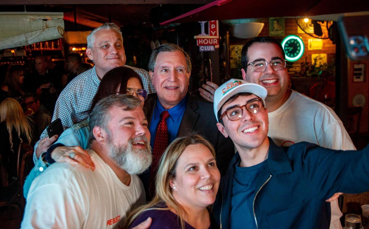 City of Miami Commissioner Joe Carollo celebrates at Old’s Havana Cuban Bar and Cocina in Little Havana with his wife Marjorie Carollo, second from left, his Chief of Staff José Suárez, far left, and supporters after winning the reelection for District 3 on Tuesday, Nov. 2, 2021.