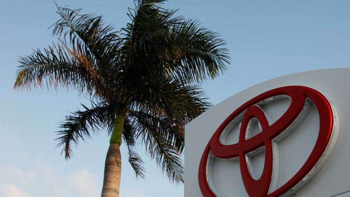 This Feb. 3, 2010 file photo shows a palm tree behind a Toyota sign at Earl Stewart Toyota in North Palm Beach, Florida.