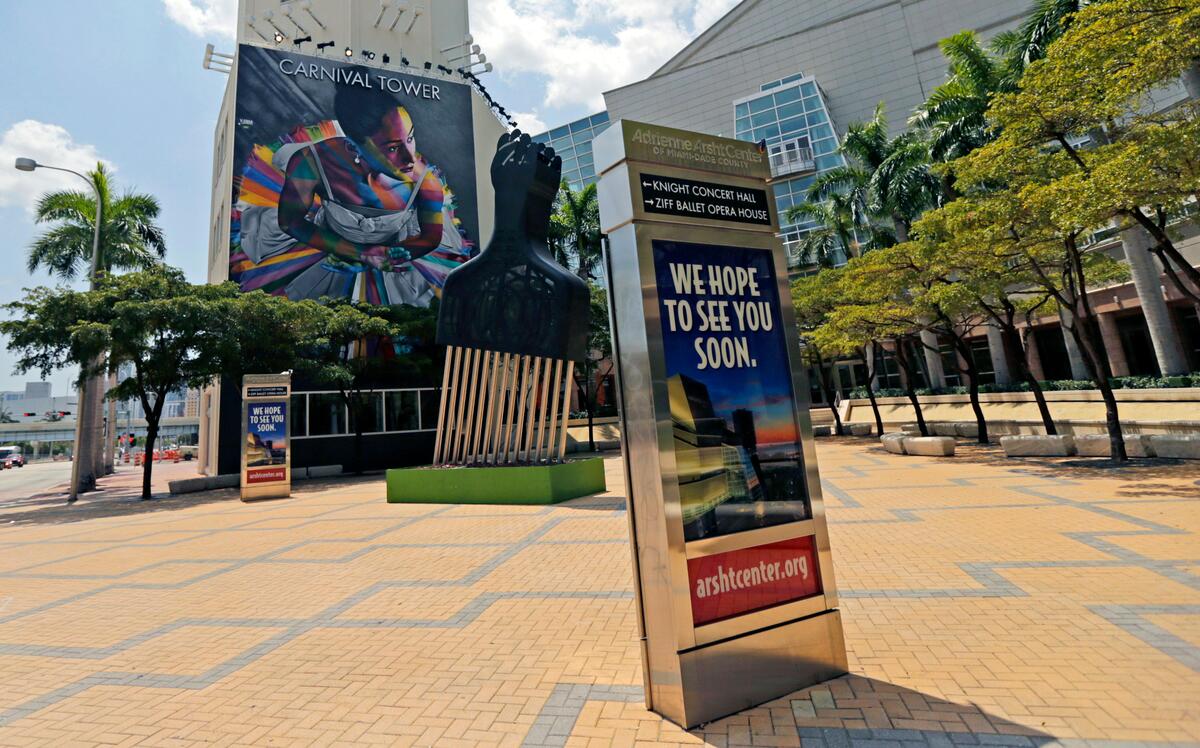A view of a couple of signs outside the Adrienne Arsht Center for the Performing Arts of Miami-Dade County on April 9, 2020, during the novel coronavirus pandemic.