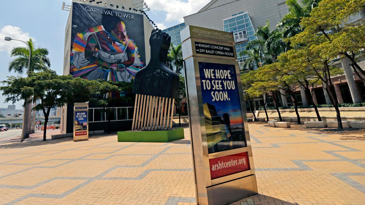 A view of a couple of signs outside the Adrienne Arsht Center for the Performing Arts of Miami-Dade County on April 9, 2020, during the novel coronavirus pandemic.