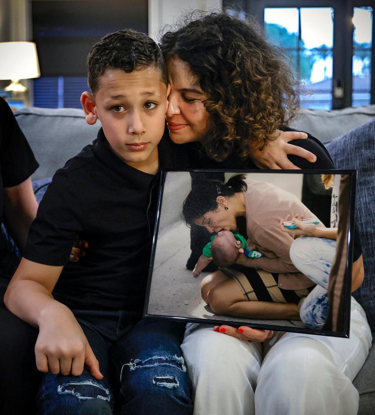 Sebastian de la Cruz,10, and his Aunt Pamela Rauseo embrace after speaking of the day 10 years ago when Sebastian stopped breathing on State Road 836.