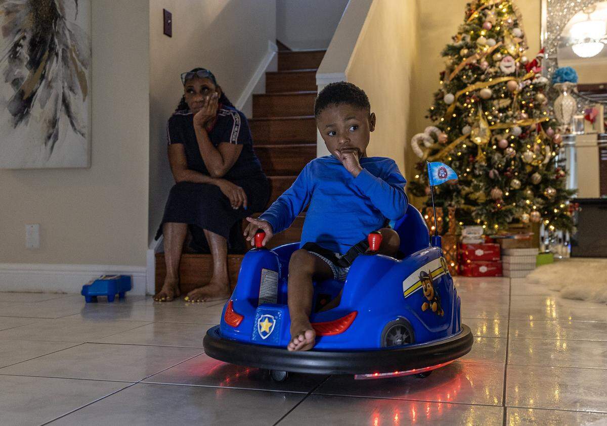 Sandra Jackson watches her grandson Jerome Scott III, 6 y.o, who is medically challenged as he plays in the livingroom of their house in Florida. He depends on his family for his care, on Saturday, December 06, 2025.