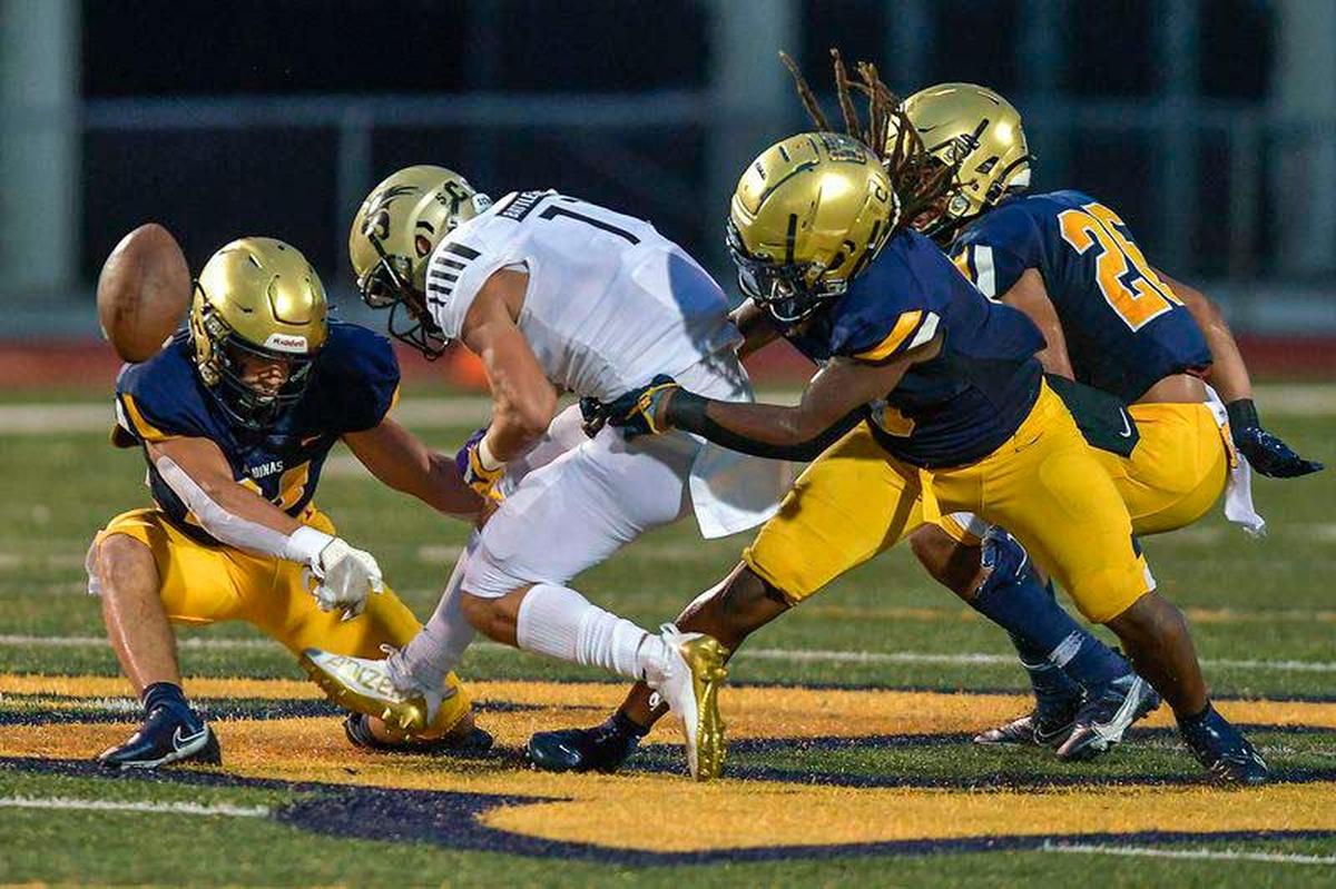 Western receiver Brennen Taranto fumbles the ball after being hit by St. Thomas Aquinas DB Nicholas Rodriguez during the first half of their game, Friday, September 24, 2021. (Michael Laughlin/Sun Sentinel)